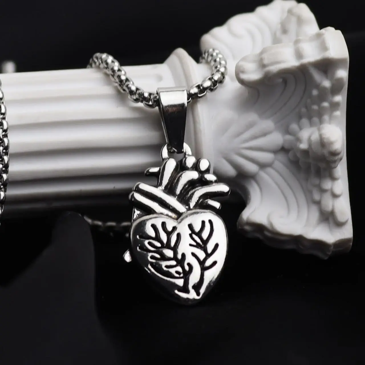 Antiqued silver anatomical heart pendant on a box chain
